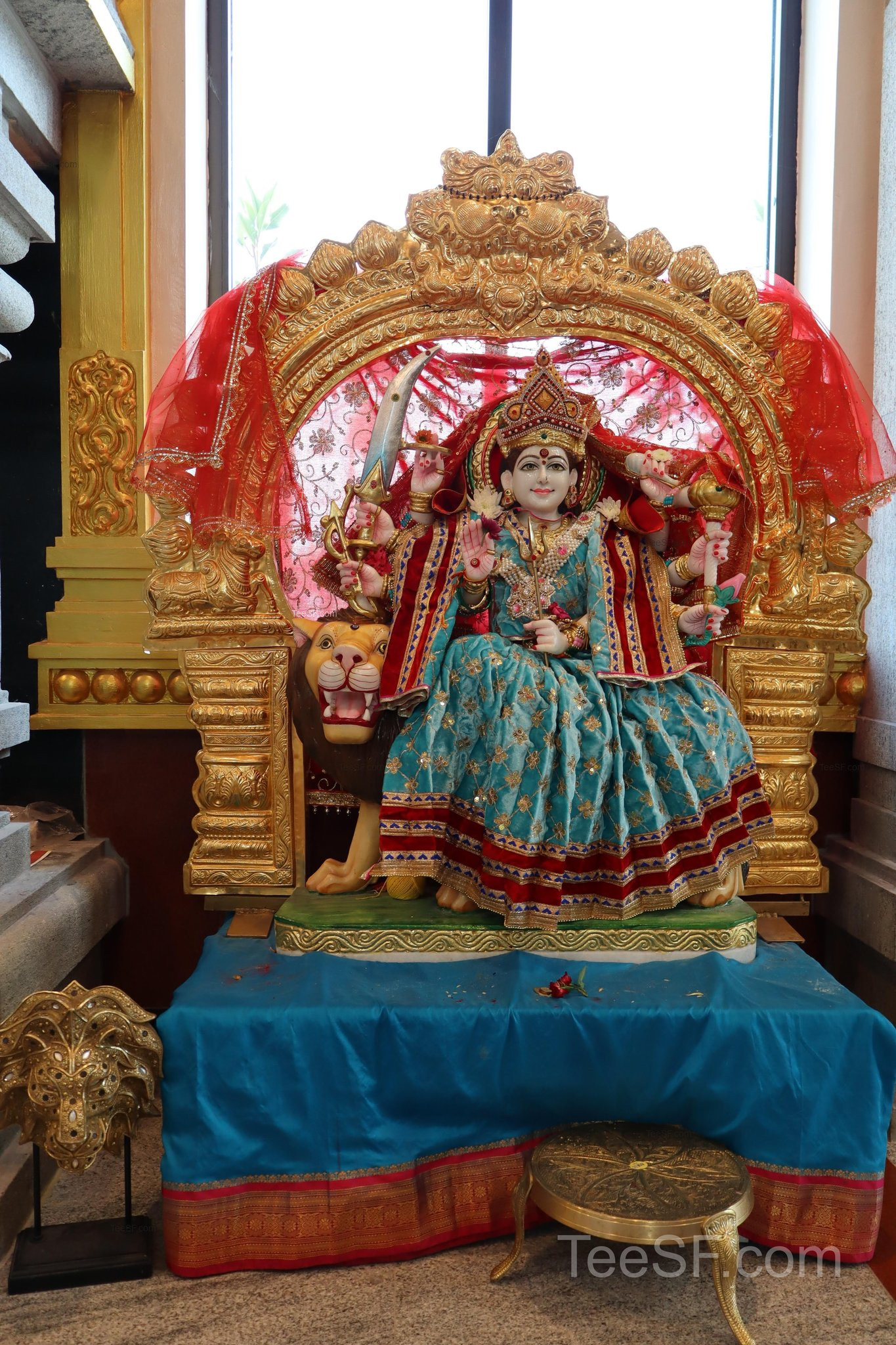 A red and gold shrine figure inside Shiva Murugan Temple.